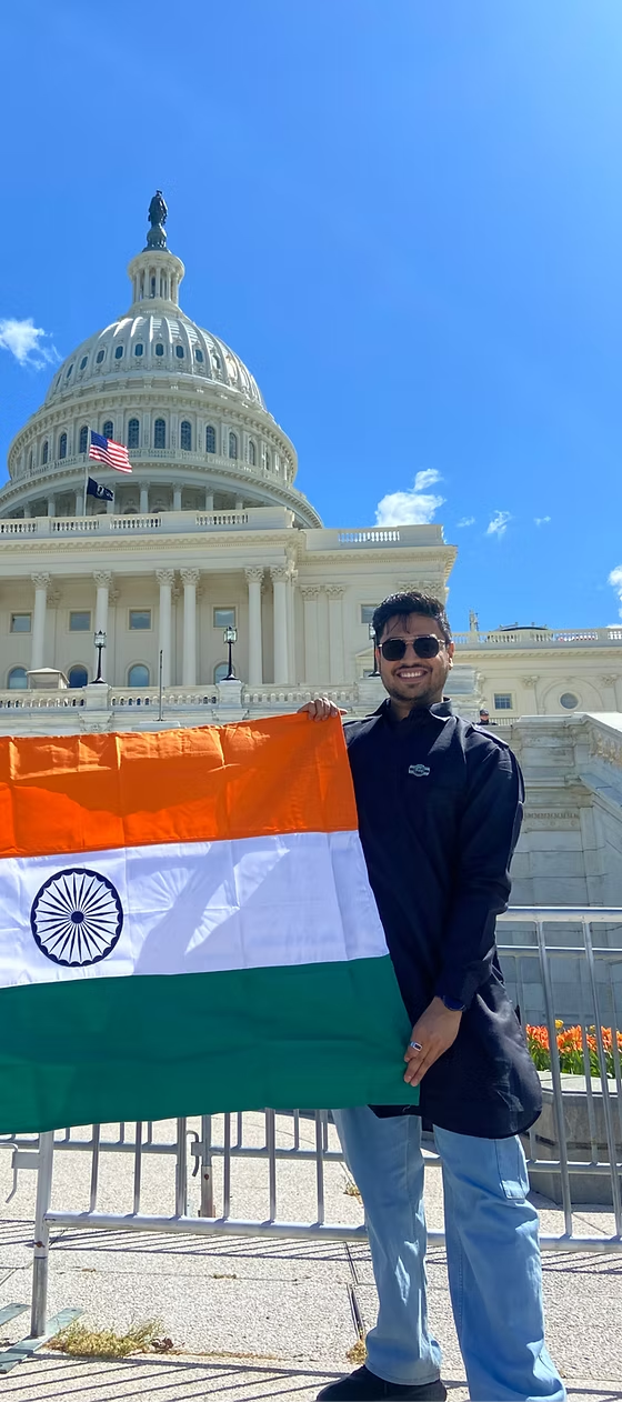 Rumit holding the Indian national flag outside the US Capitol